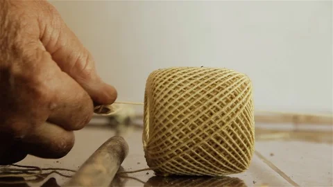 Man making a Kite with String Ball and Wood Sticks at Home. Close-Up. Stock Footage 93879866