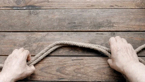 Man making a knot in a rope Stock Footage 109275685