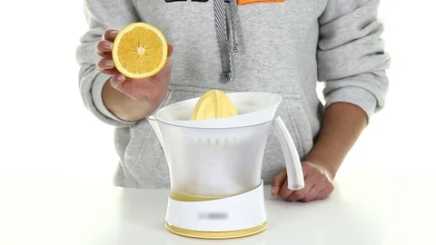 Man is making lemon juice in the hand juicer Stock Footage 69913490