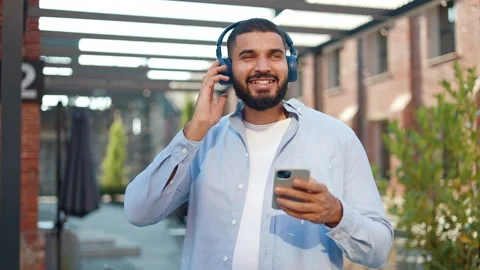 Man making light body movements when feeling enjoyment from listening great song Video stock 250389859