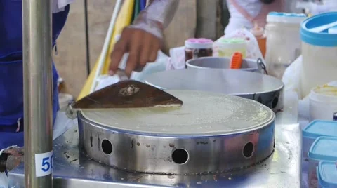 Man making local pancakes crape Stock Footage 50525765