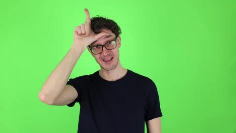 Man making loser gesture, L sign on forehead. Concept - you lose! 動画素材 303143643