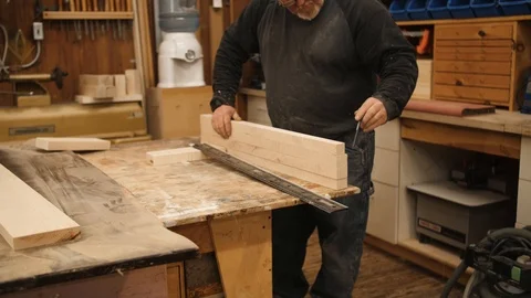 Man making marks on boards with pen in workshop Stock Footage 102045405