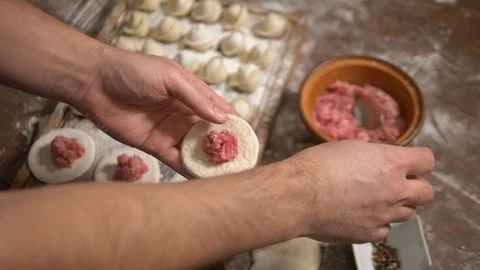 Man making meat dumpling at home, top view Stock Footage 126584755