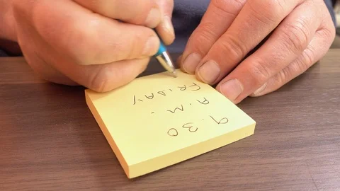 Man making a note of a time and day. Stock Footage 89604986