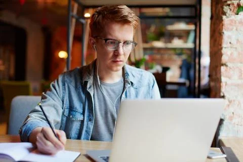 Man making notes in the textbook. Stock Photos
