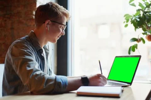 Man making notes in the textbook. Stock Photos