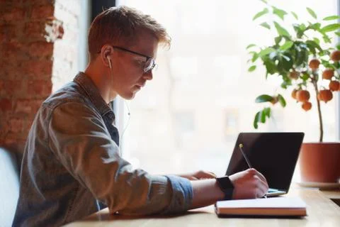 Man making notes in the textbook. Stock Photos
