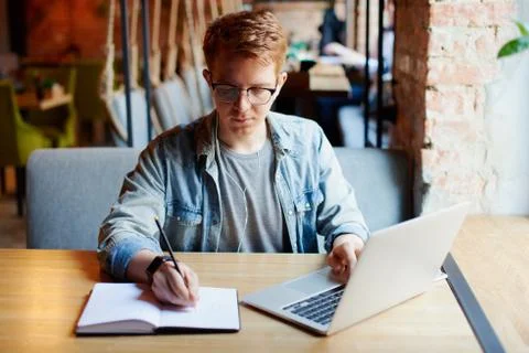 Man making notes in the textbook. Stock Photos