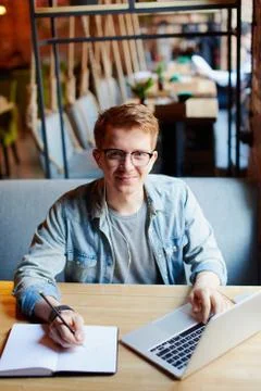 Man making notes in the textbook. Stock Photos