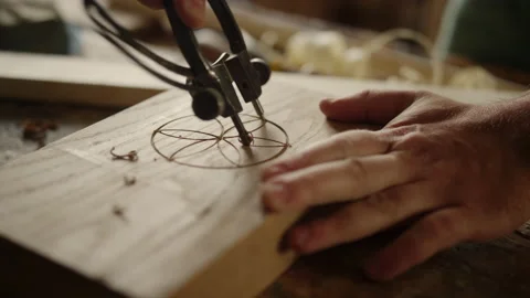 Man making pattern on wooden product indoors. Carpenter using tool for carving Stock Footage 148307458