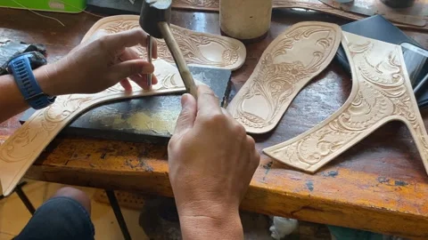 A man is making a patterned leather for the leather shoes Stock Footage 259037887