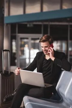 Man making a phone call while waiting for the boarding Stock Photos