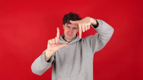 Man making photo frame gesture with hands, filled creativity imagination. 動画素材 304746664