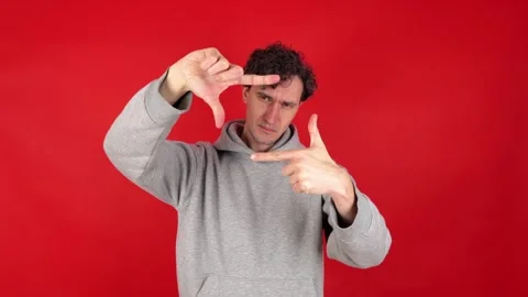Man making photo frame gesture with hands, filled creativity imagination Stockbeeldmateriaal 304746833