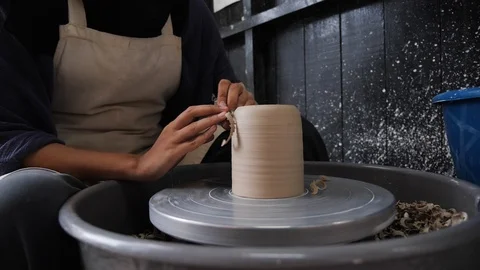 Man making pottery on spinning table in indoor workshop, Malaysia Stock Footage 146564312