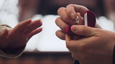 Man making proposal to his girlfriend with wedding ring with stone, engagement Stock Footage 83762154