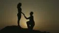 Man making proposal to woman at dawn in mountains. Happy couple in love engaging HD Footage