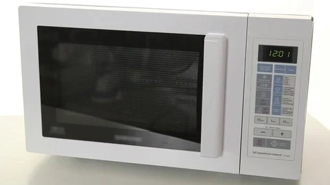 Man is making puff cake close-up in the kitchen with using microwave oven Stock Footage 69913213