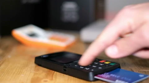 Man making purchase payment to a customer with credit card machine, cashless pay Stock Footage 145115741