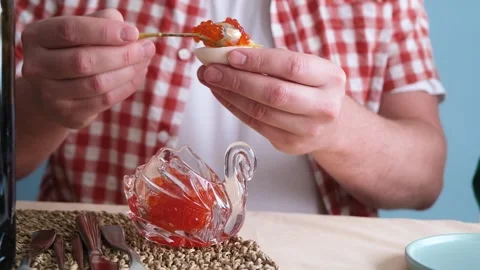 Man making red caviar toasts Stock Footage 303635733