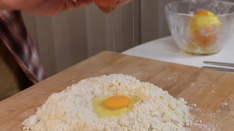 A man is making sand dough for a pie. Close-up of hands 動画素材 286097274