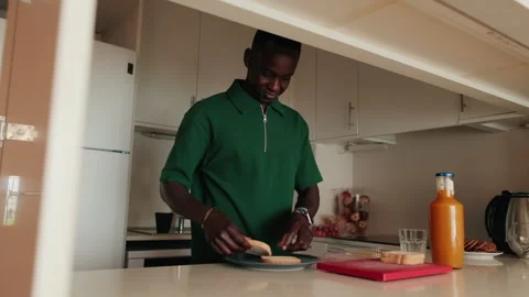 Man Making a Sandwich in a Modern Kitchen Stock Footage 303778050