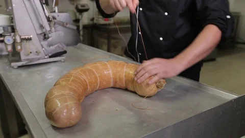 The man making the sausage. rewinding thread Stock Footage 75242990