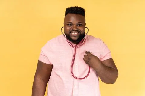Man making self examining with stethoscope, looking at camera with toothy smile. Stock Photos