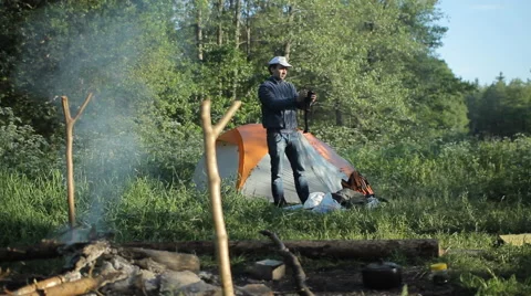 Man making selfie with camera in camping Stock Footage 64050304