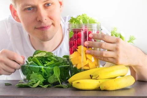 Man making smoothie Stock Photos