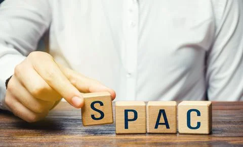 Man making SPAC word from blocks. in a row. A easy way stock exchange financi Stock Photos