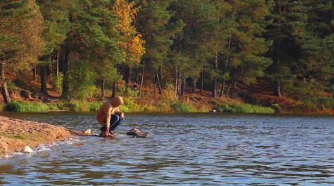 Man making splashes on the lake Stock Footage 42771466