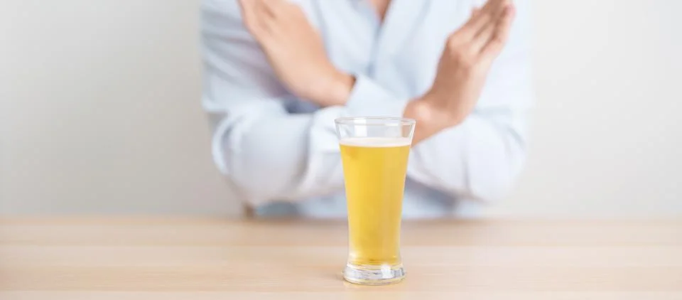Man making stop hand gesture to refuse a glass of Beer, Healthy man say no .. Stock Photos
