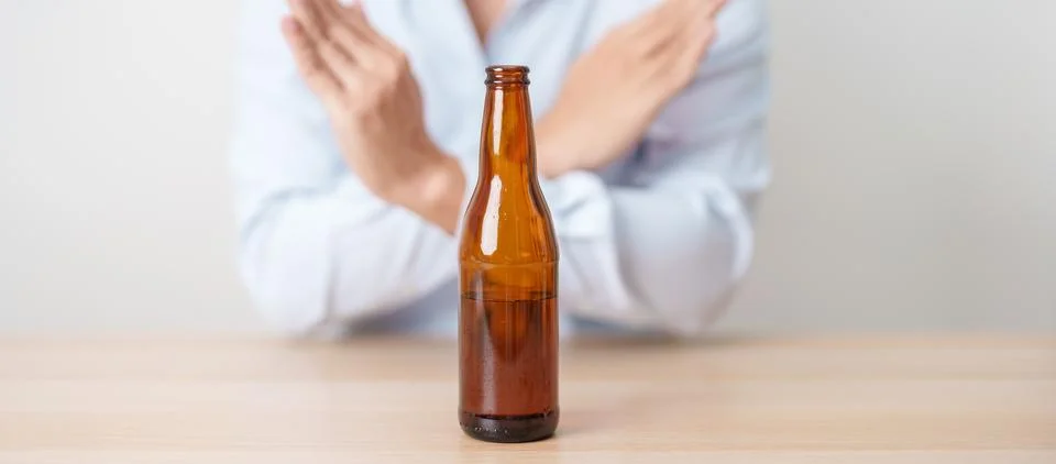 Man making stop hand gesture to refuse a bottle of Beer, Healthy man say no.. Stock Photos