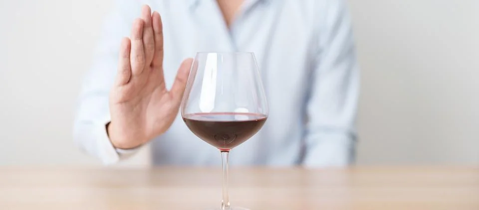 Man making stop hand gesture to refuse a glass of Wine, Healthy man say no .. Stock Photos