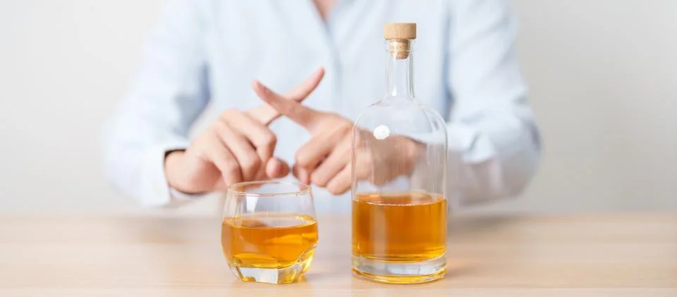 Man making stop hand gesture to refuse a glass of whiskey, Healthy man say .. Stock Photos