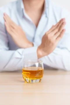 Man making stop hand gesture to refuse a glass of whiskey, Healthy man say .. Stock Photos