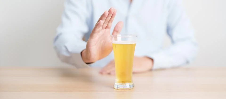 Man making stop hand gesture to refuse a glass of Beer, Healthy man say no .. Stock-Fotos