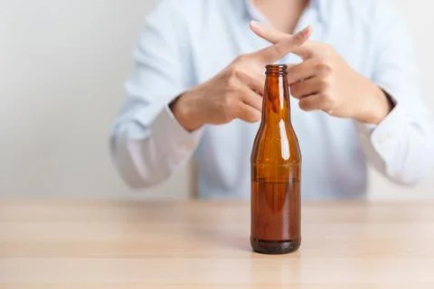 Man making stop hand gesture to refuse a bottle of Beer, Healthy man say no.. Stock-Fotos