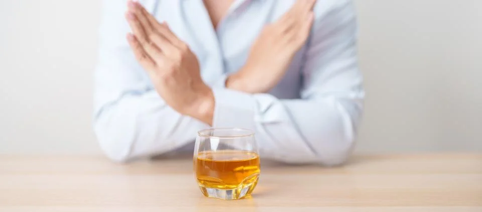 Man making stop hand gesture to refuse a glass of whiskey, Healthy man say .. Stock-Fotos