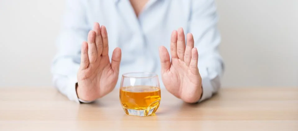 Man making stop hand gesture to refuse a glass of whiskey, Healthy man say .. Stock-Fotos
