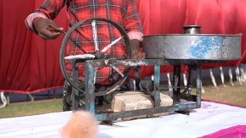 Man Making Sugar Candy using old Cotton Candy Floss Maker Machine Street Stock Footage 121835127