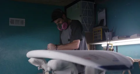 Man making a surfboard, using a surfboard planer Stock Footage 107641202