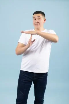 Man Making Timeout Hand Gesture on Blue Background Stock Photos