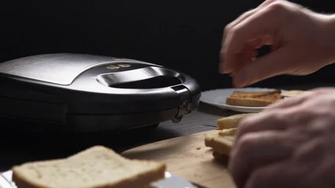 Man making toasts with electric grill Stock Footage 104064039