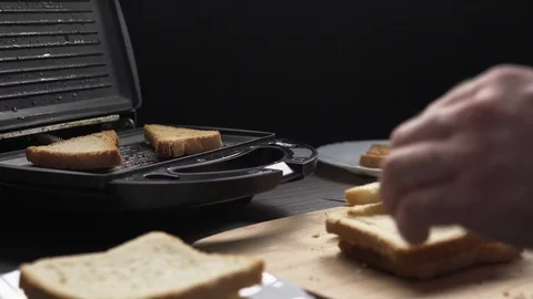 Man making toasts with electric grill Stock Footage 104064277