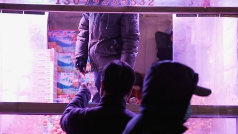 Man making transaction outside fruit stall as people walk by, China, Shenyang 스톡 동영상 84757199