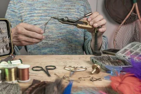 Man making trout flies. Fly tying equipment and material for fly fishing pr.. Stock Photos