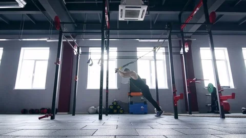 Man making trx lunge press exersices Stock Footage 73993682